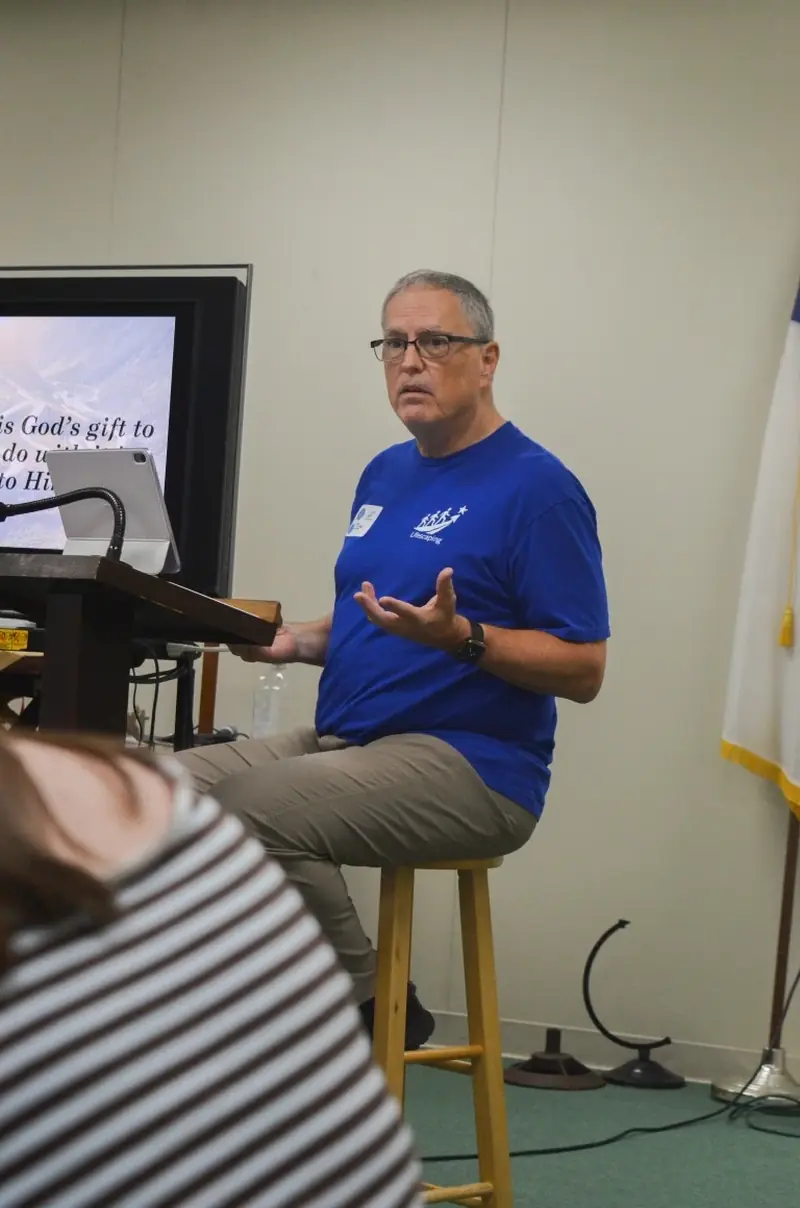 Don Walter teaching from a stool during the Global Youth session