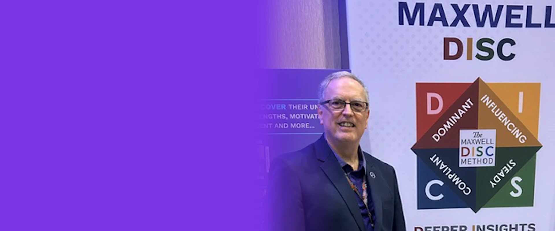 Don Walter standing beside a Maxwell DISC Method display at a leadership conference