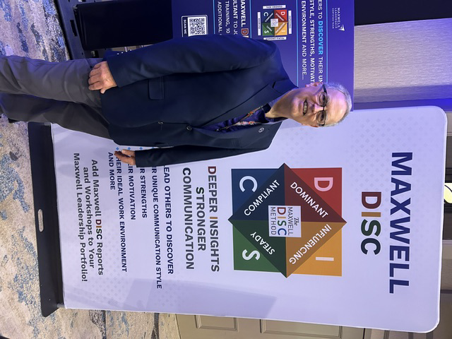 Don Walter in front of a Maxwell DISC personality assessment display
