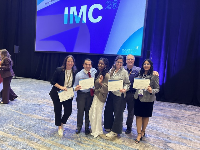 Leadership team celebrating together on stage at IMC 26